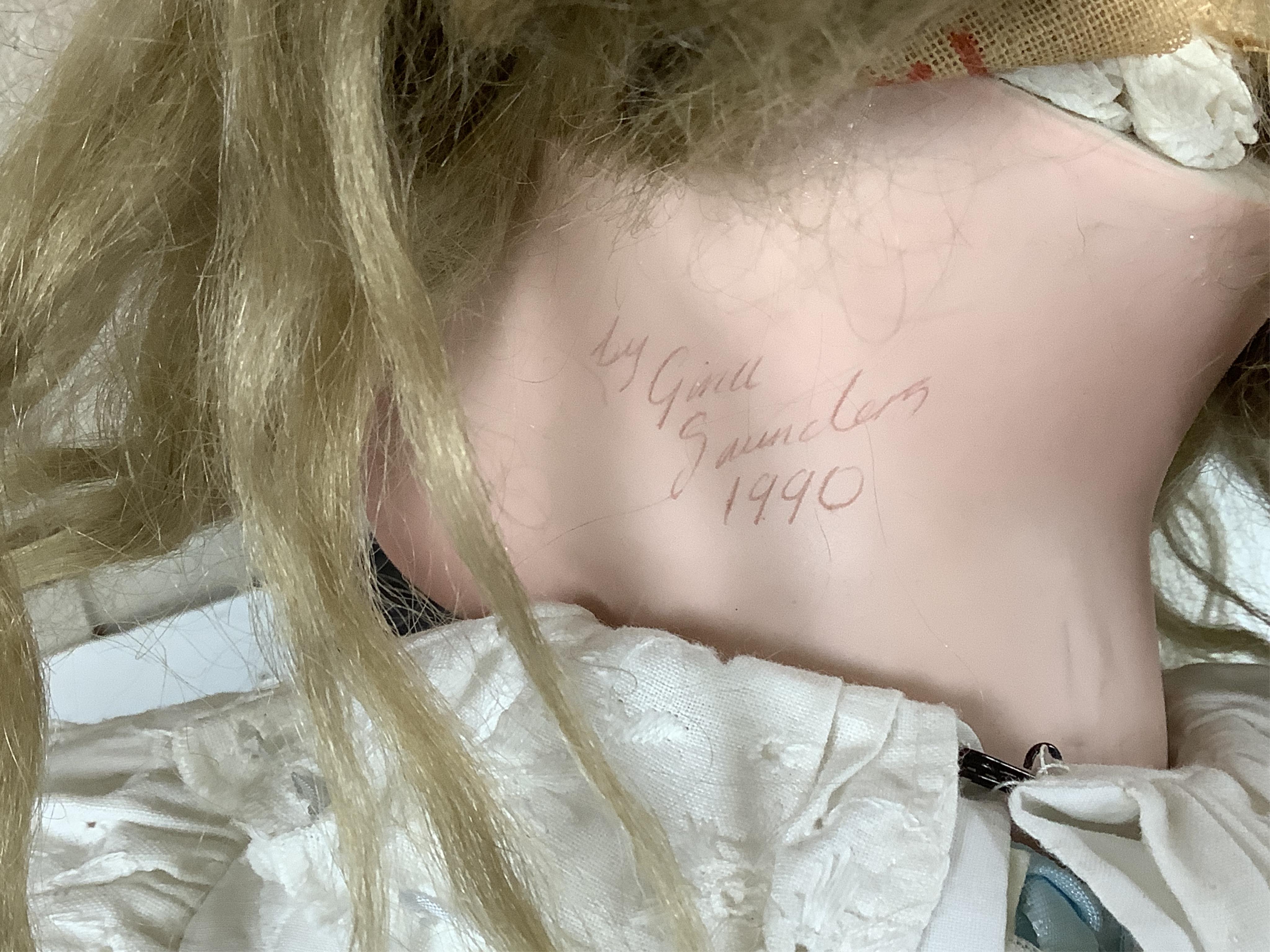 A large jointed bisque head doll and two miniature bisque dolls